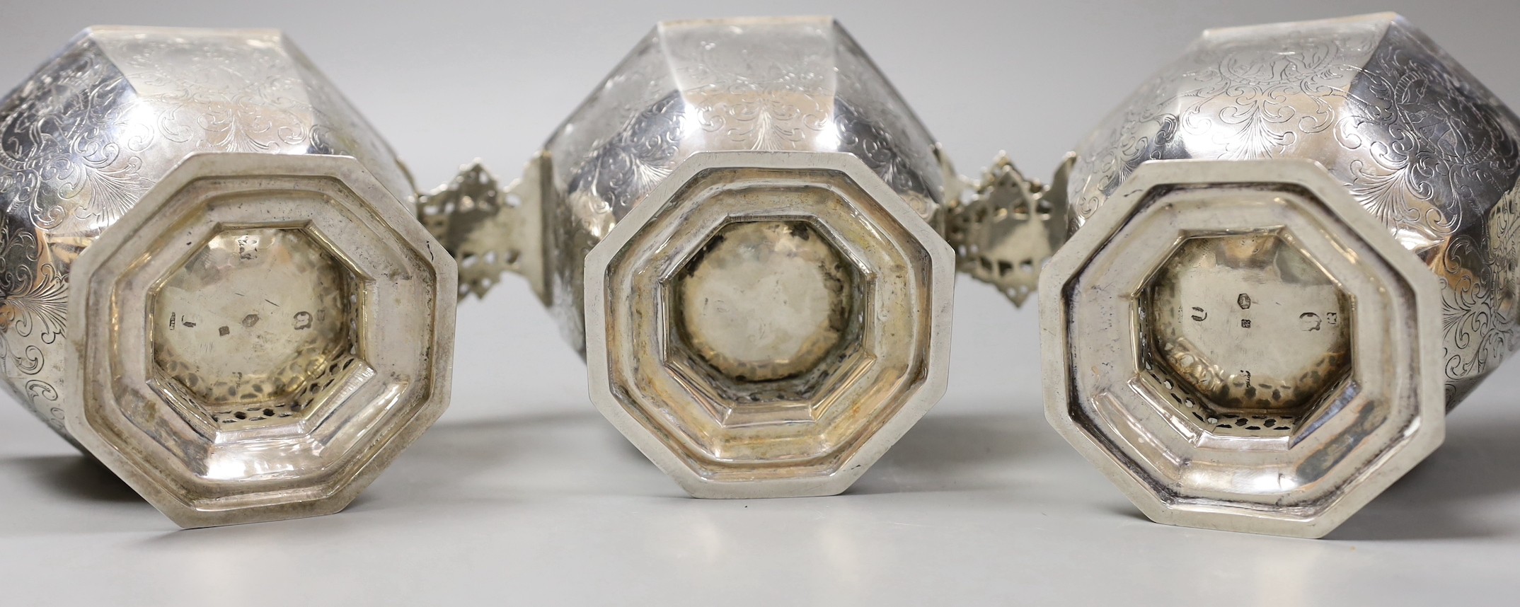 A set of three 19th century Dutch 833 standard white metal octagonal twin mask handled octagonal pedestal bowls, height 10cm, 35.9 oz.
